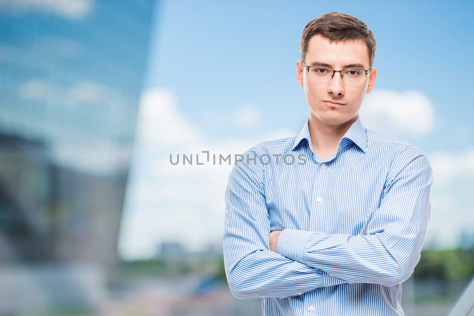 Businessman in glasses young and very successful, in office