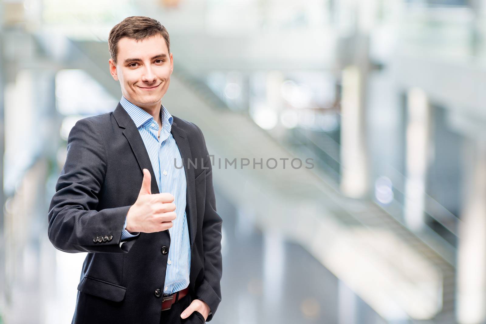 Smiling young male business executive in office portrait
