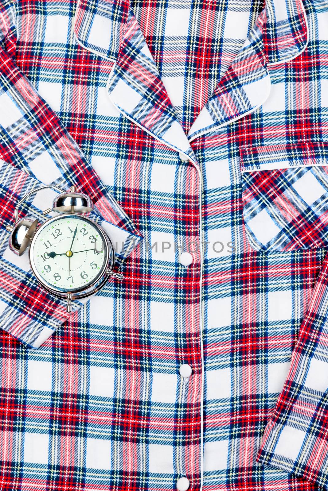 Classic checkered pajamas in full frame and a retro alarm clock