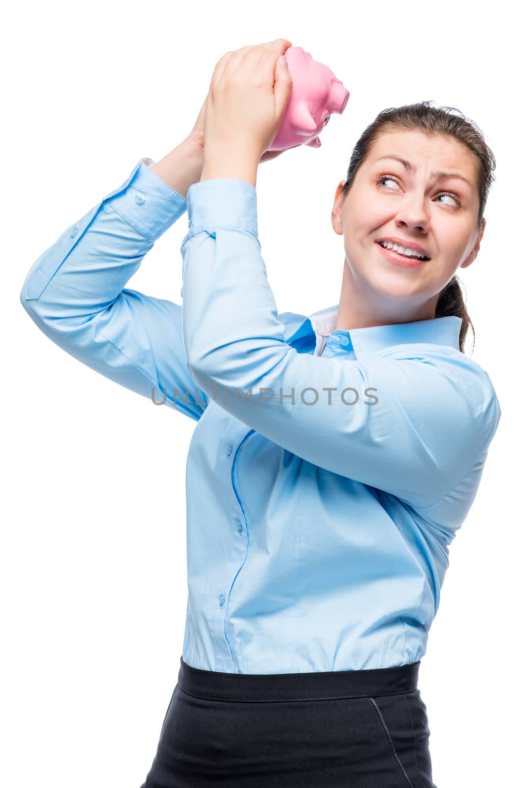 Portrait of a girl with a pink piggy bank in the studio on a white background