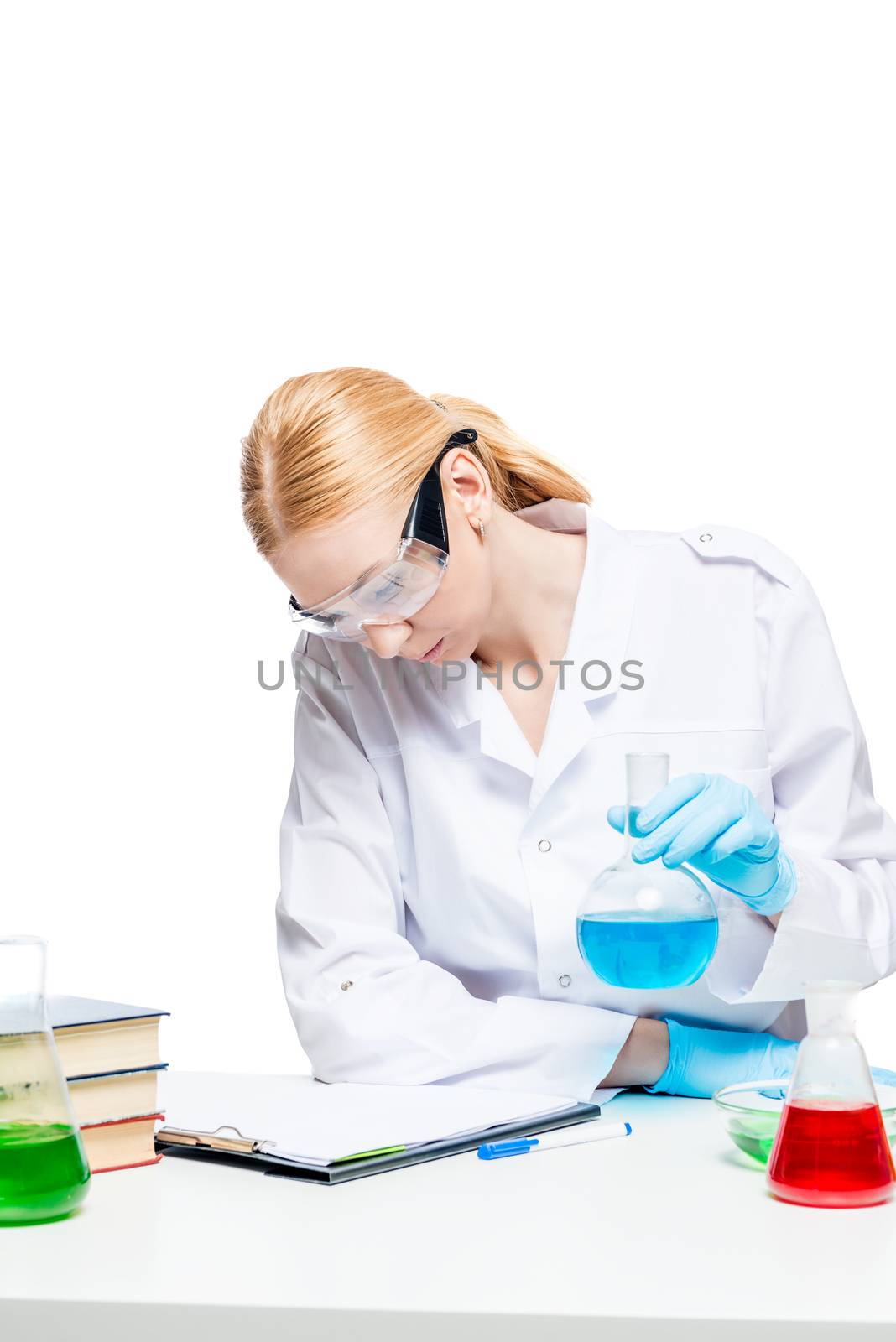 Girl chemist lab assistant doing analysis at the table