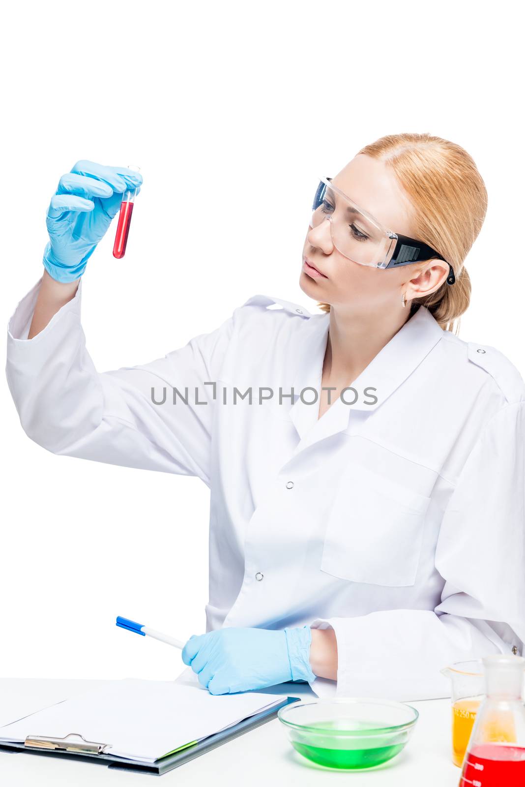 Beautiful female lab assistant with test tubes posing on white background