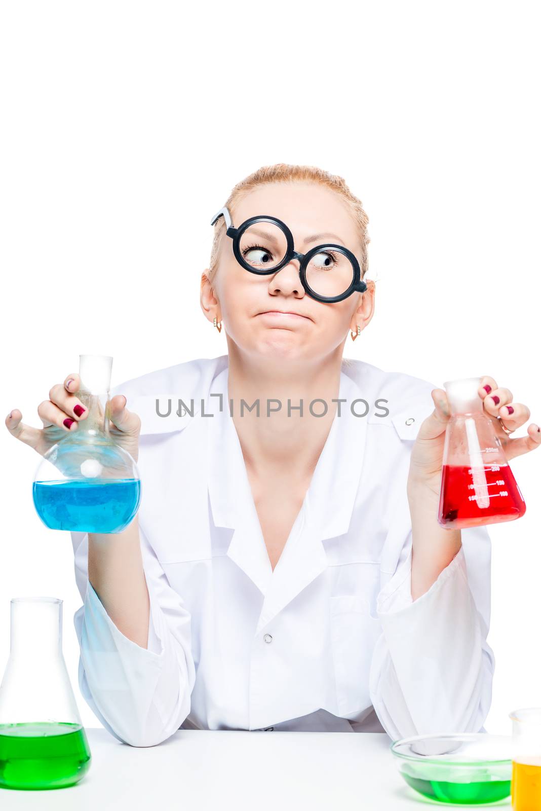 tired crazy chemist in glasses with test tubes conducting experiments in the laboratory