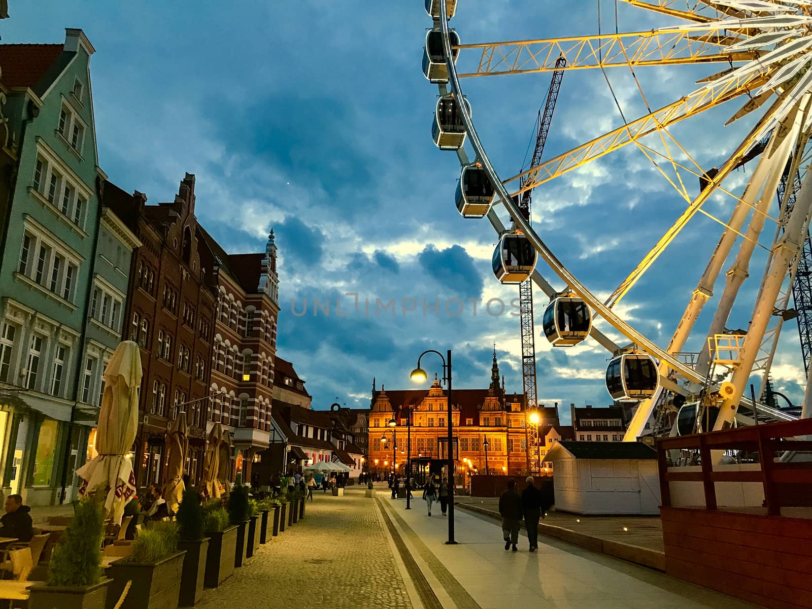 Great evening Ferris wheel in Gdansk, Poland against the background of old cityscape