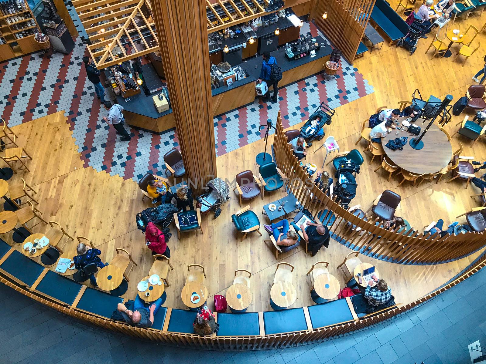 Visitors at the coffee shop in the shopping center in Stockholm, Sweden. Top view, from above