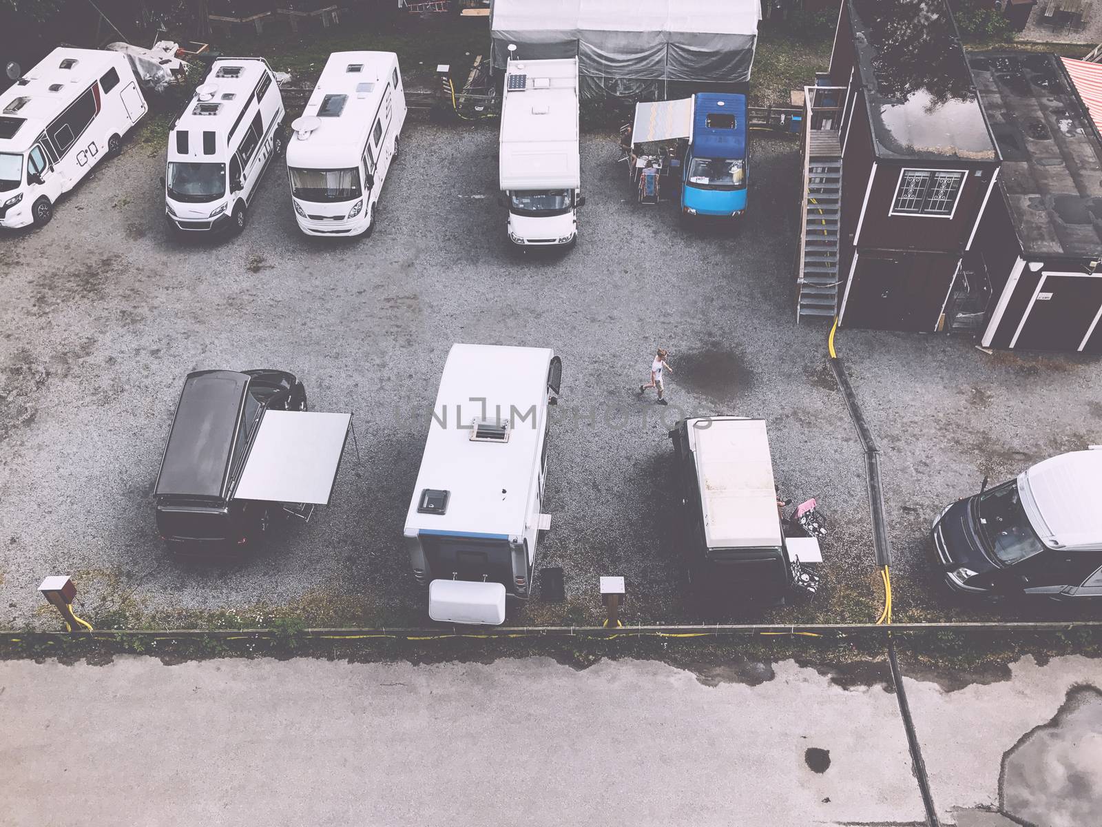 Trucks settlement. Aerial view of camping in Stockholm, Sweden. Summer seascape with trucks, sunny day. Top view from flying drone