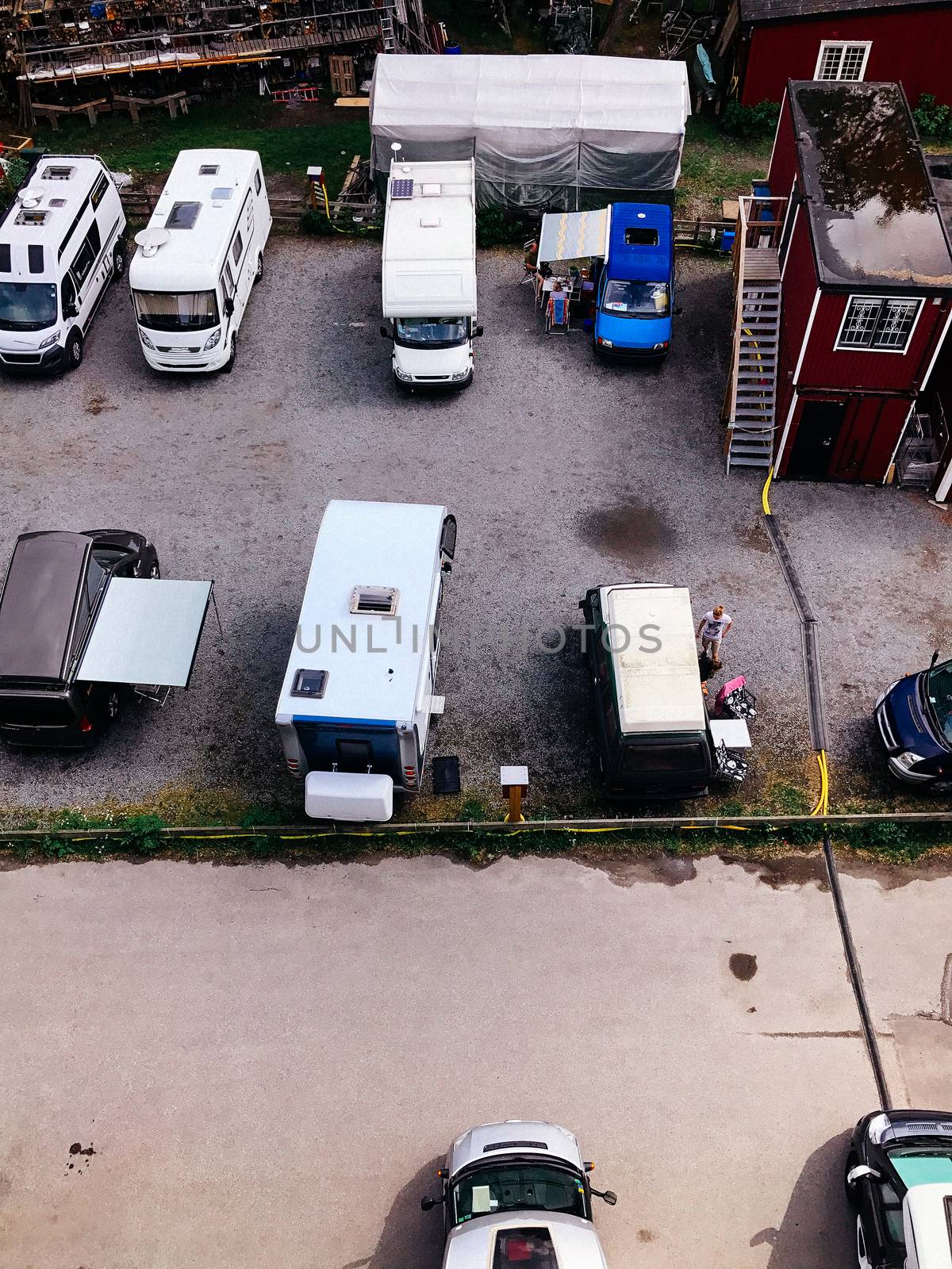 Trucks settlement. Aerial view of camping in Stockholm, Sweden. Summer seascape with trucks, sunny day. Top view from flying drone