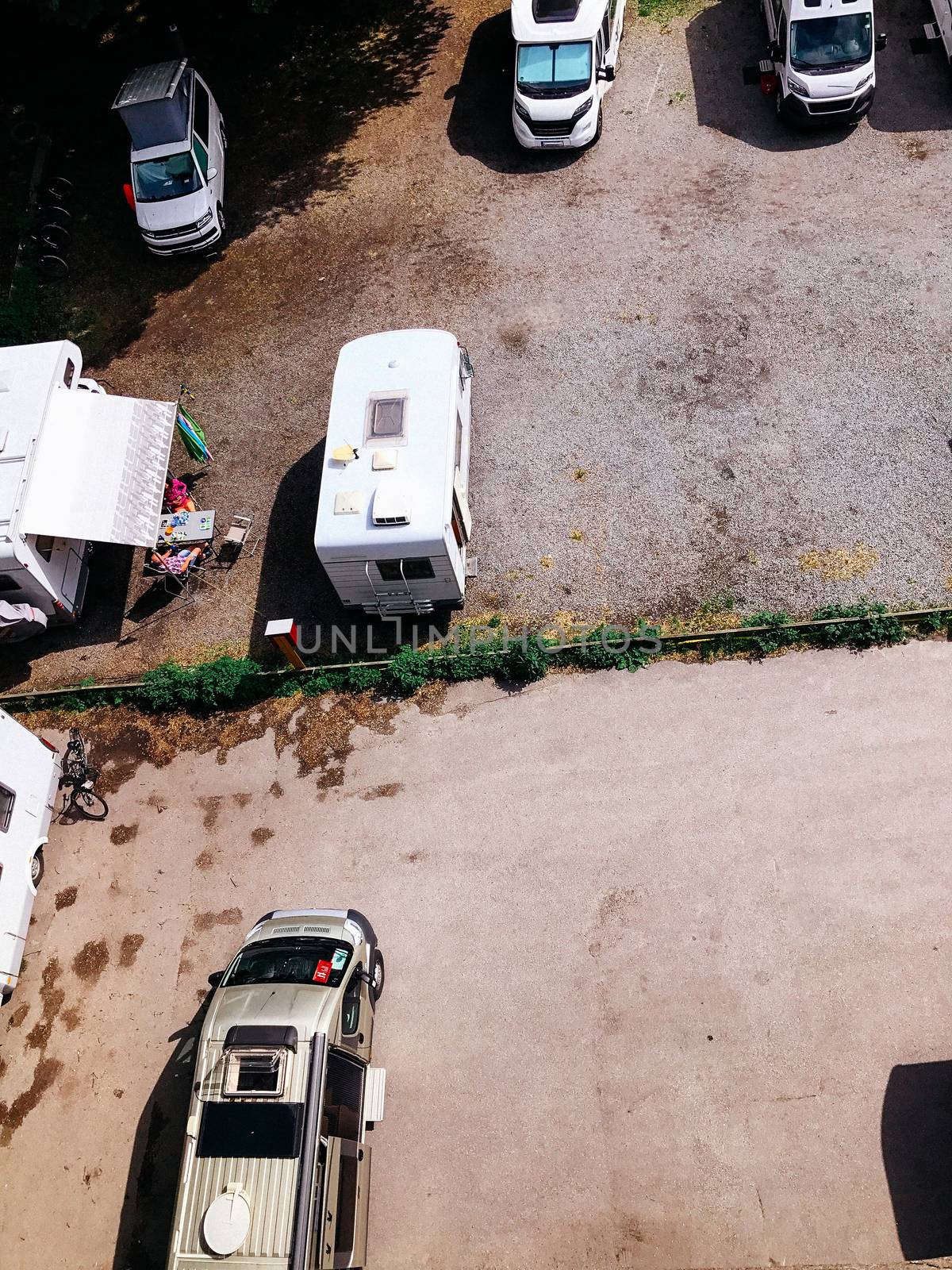 Trucks settlement. Aerial view of camping in Stockholm, Sweden. Summer seascape with trucks, sunny day. Top view from flying drone