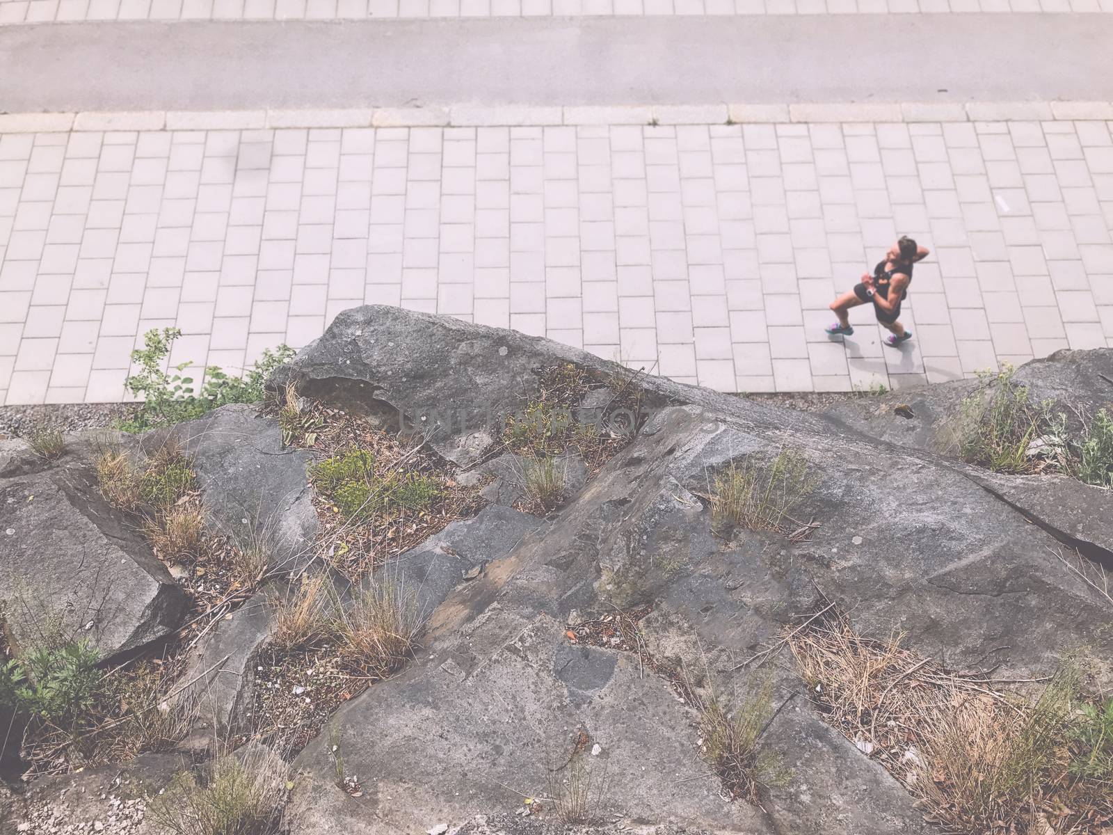 Swedish sportswoman runs around mountain in the morning, Stockholm, Sweden. Top view, from above