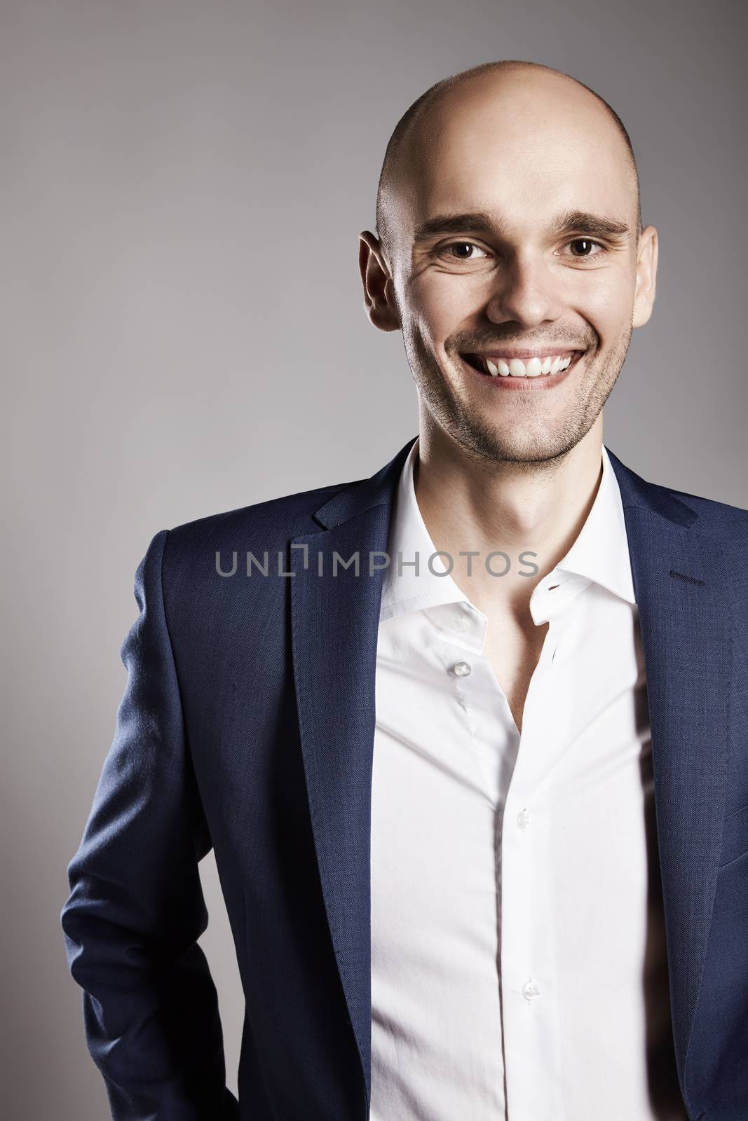 Portrait of cheerful relaxed smiling young man looking to the camera. 