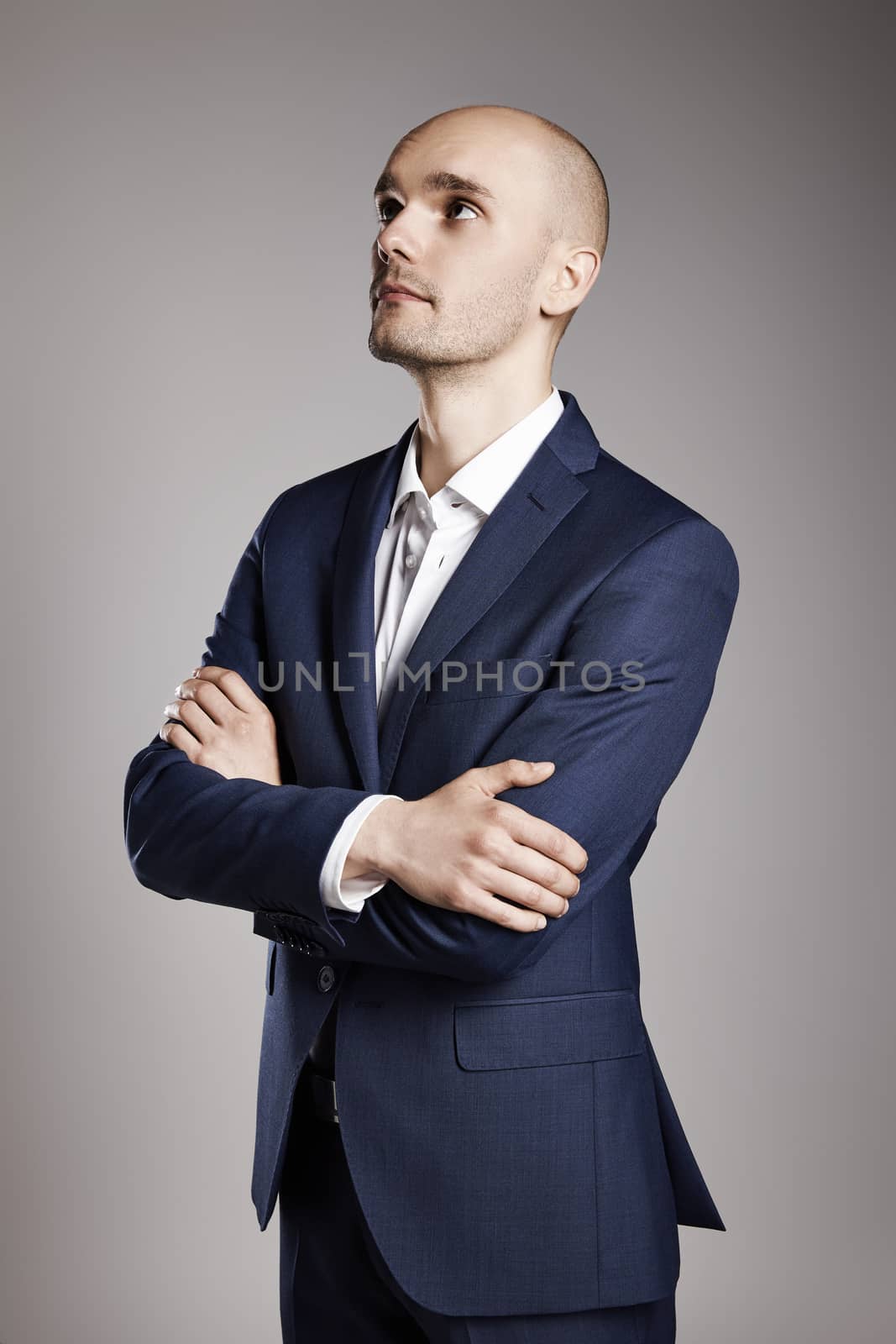 Portrait of young pensive man looking up.