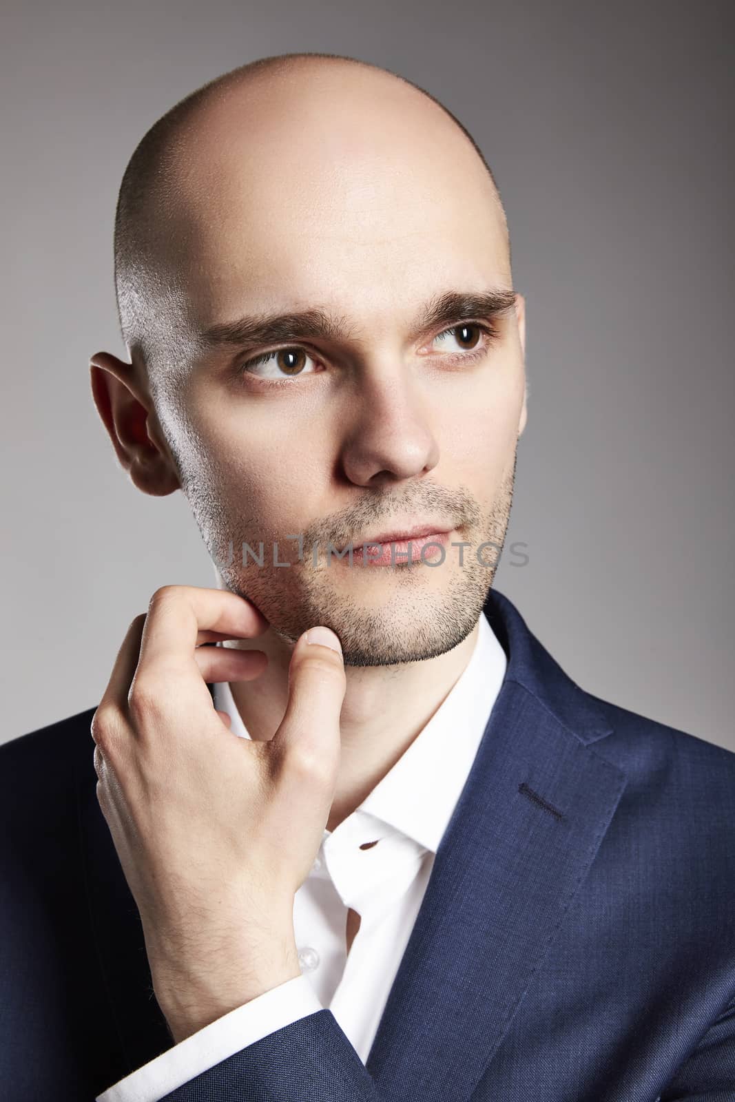 Close up of pensive young man in suit.