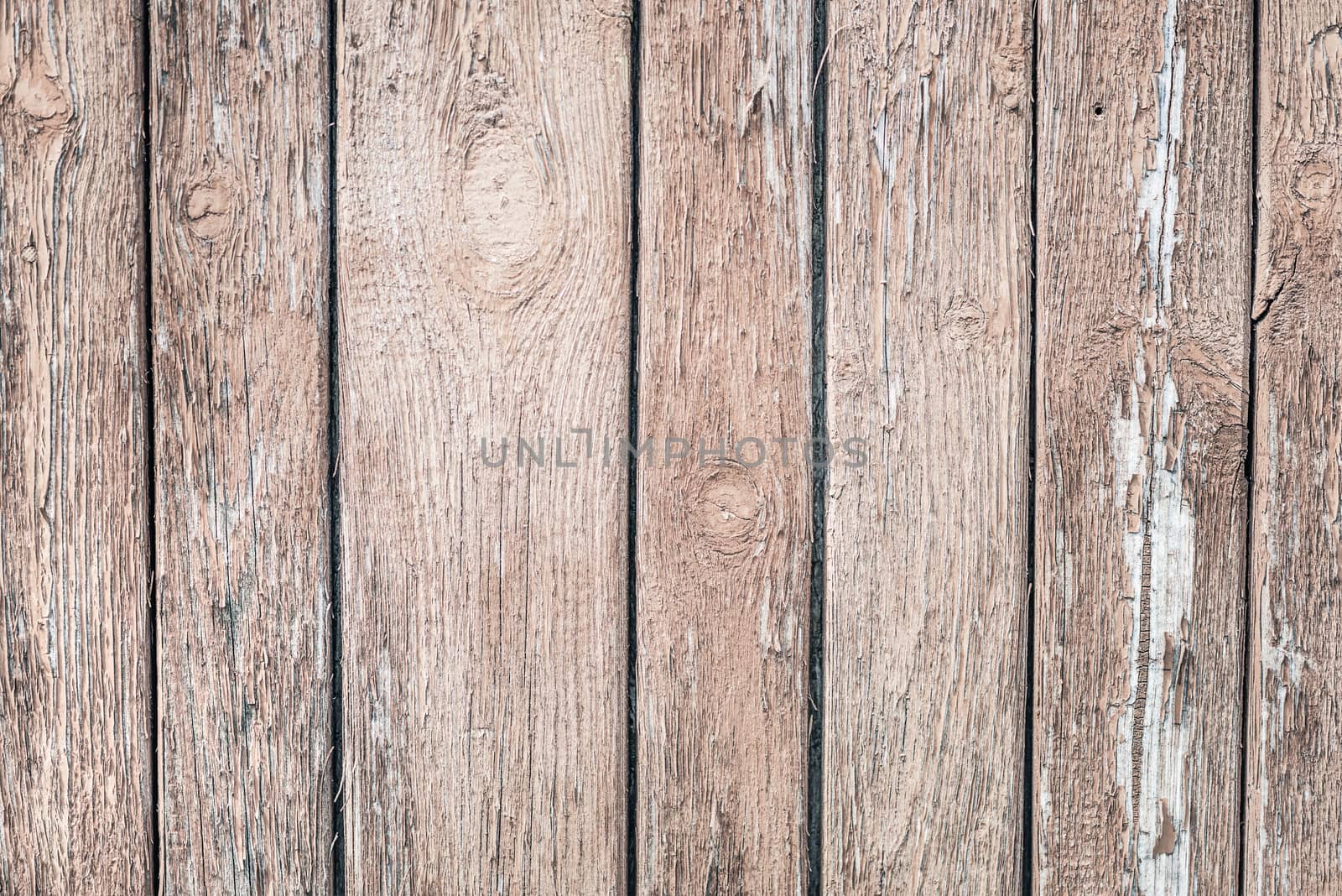 Wooden grunge background from the old brown unpainted boards closeup