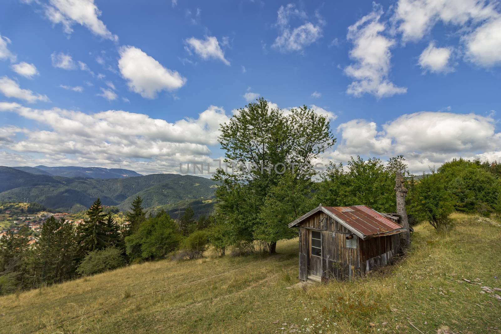 beauty daily landscape of alone old wooden house on a hill in a mountain