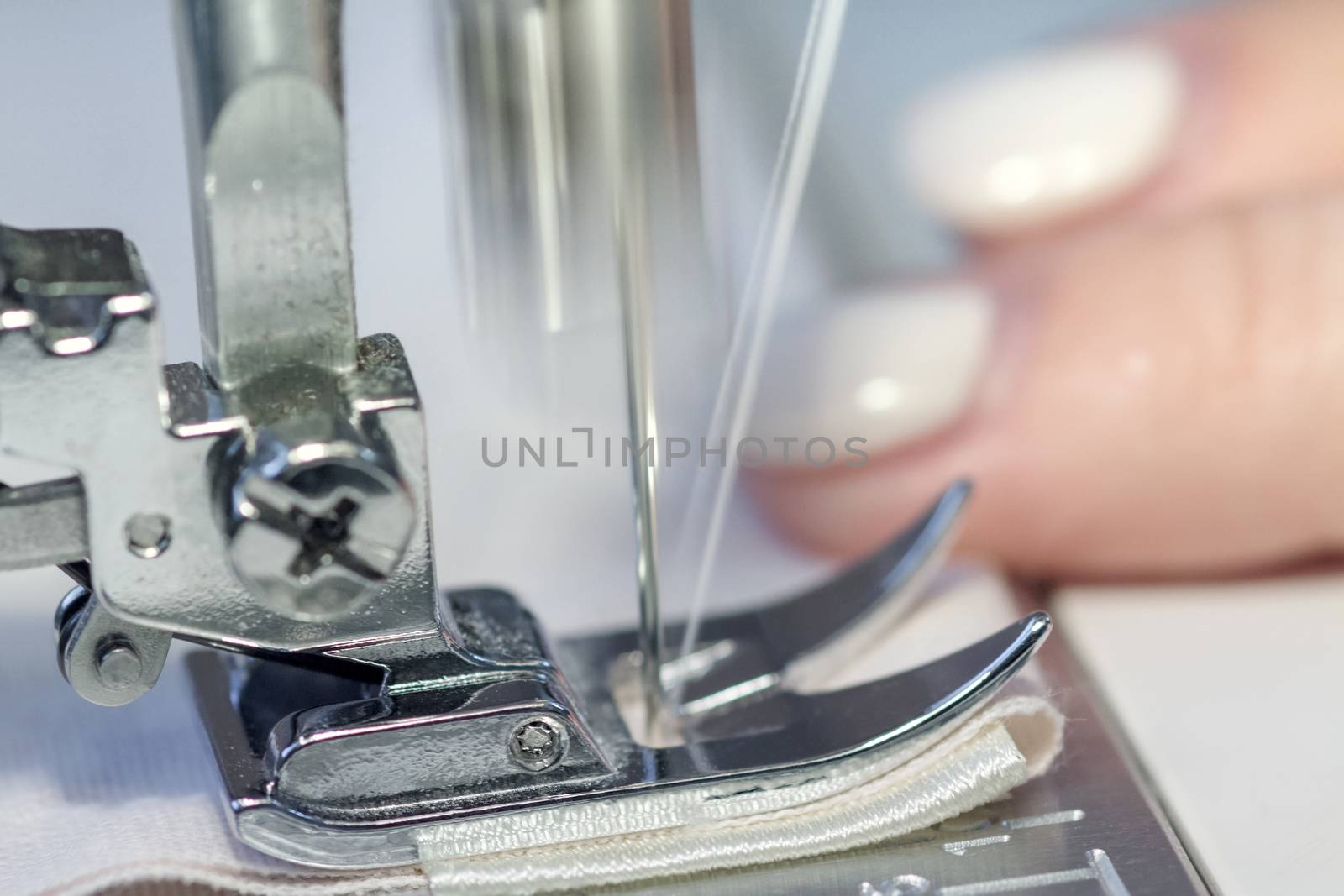 threading a needle thread sewing machine close-up