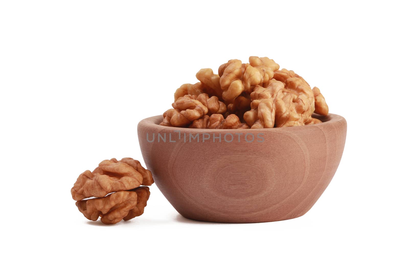 Walnuts shelled in a bowl isolated on white background. Side view. Walnut kernels in a bowl