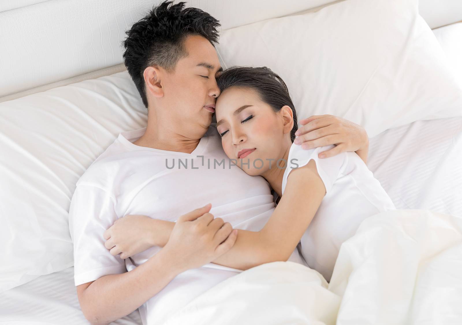 Young loving couple in the bed. Modern lifestyle concept