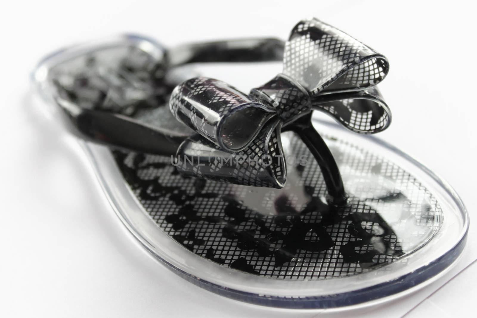 Transparent flip flops with black flowers, on the white background by Kasia_Lawrynowicz