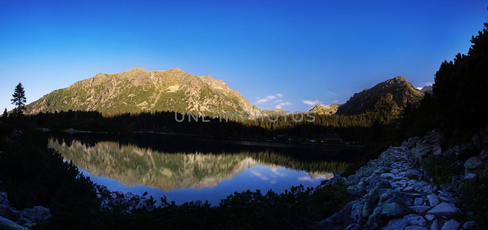 Alpine lake Popradske pleso in the morning with a great view on Tatra mountains.