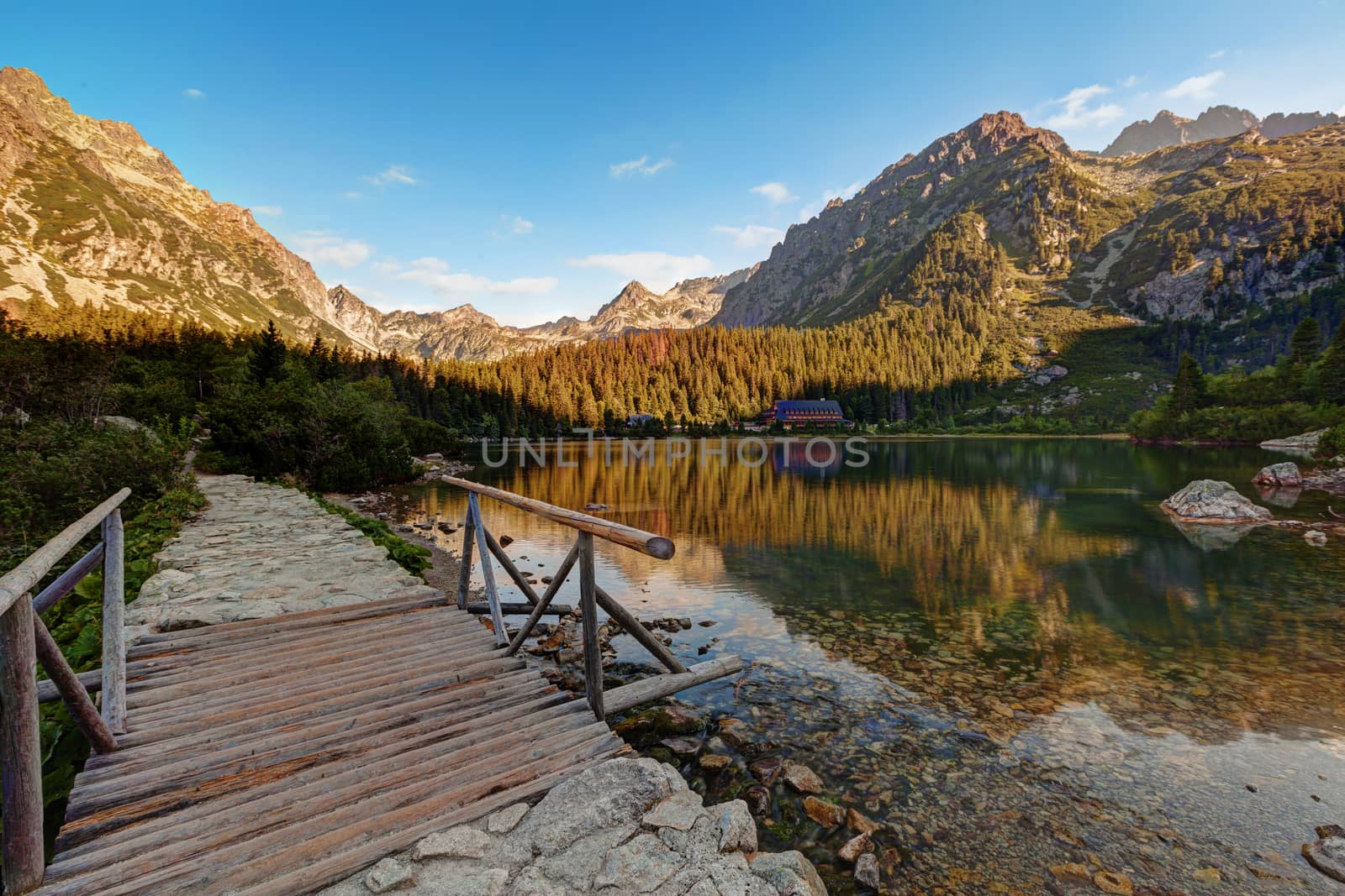 Alpine lake Popradske pleso in the morning with a great view on Tatra mountains.