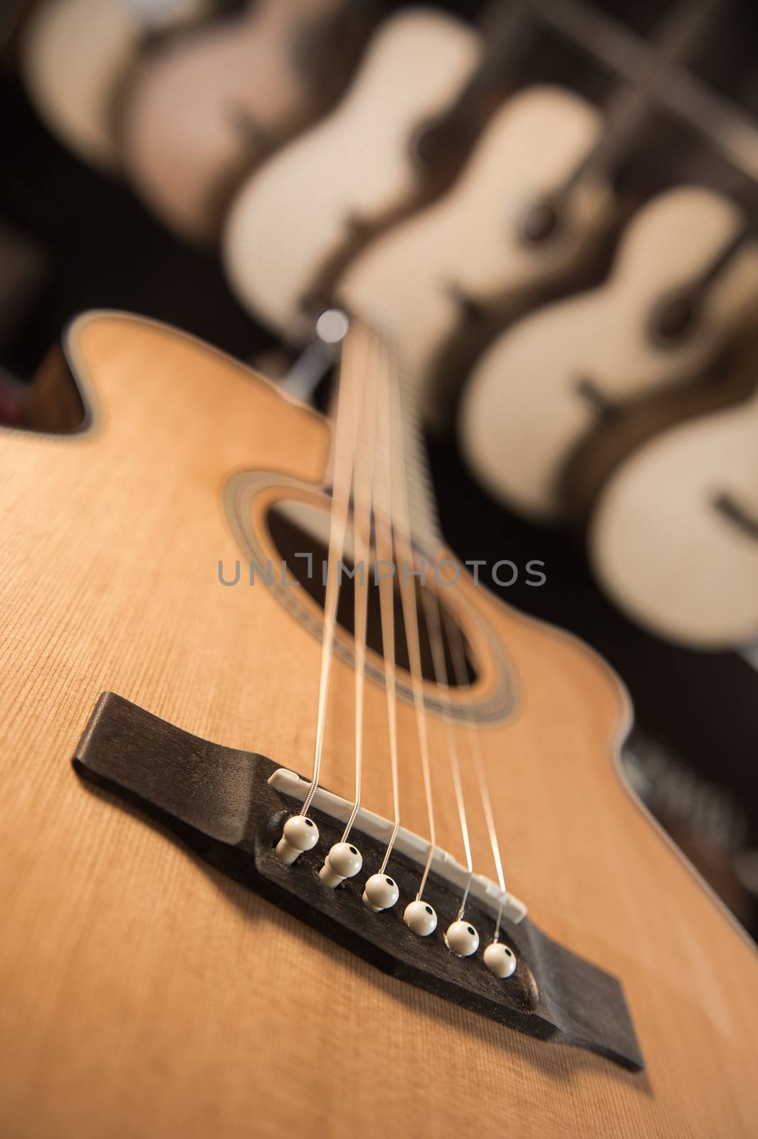 Many Classical Guitars Hanging on Wall in the Shop, France