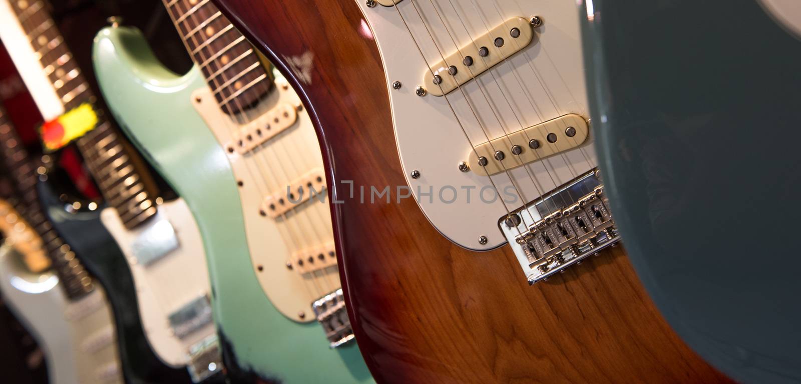 Many electric guitars hanging on wall in the shop, France