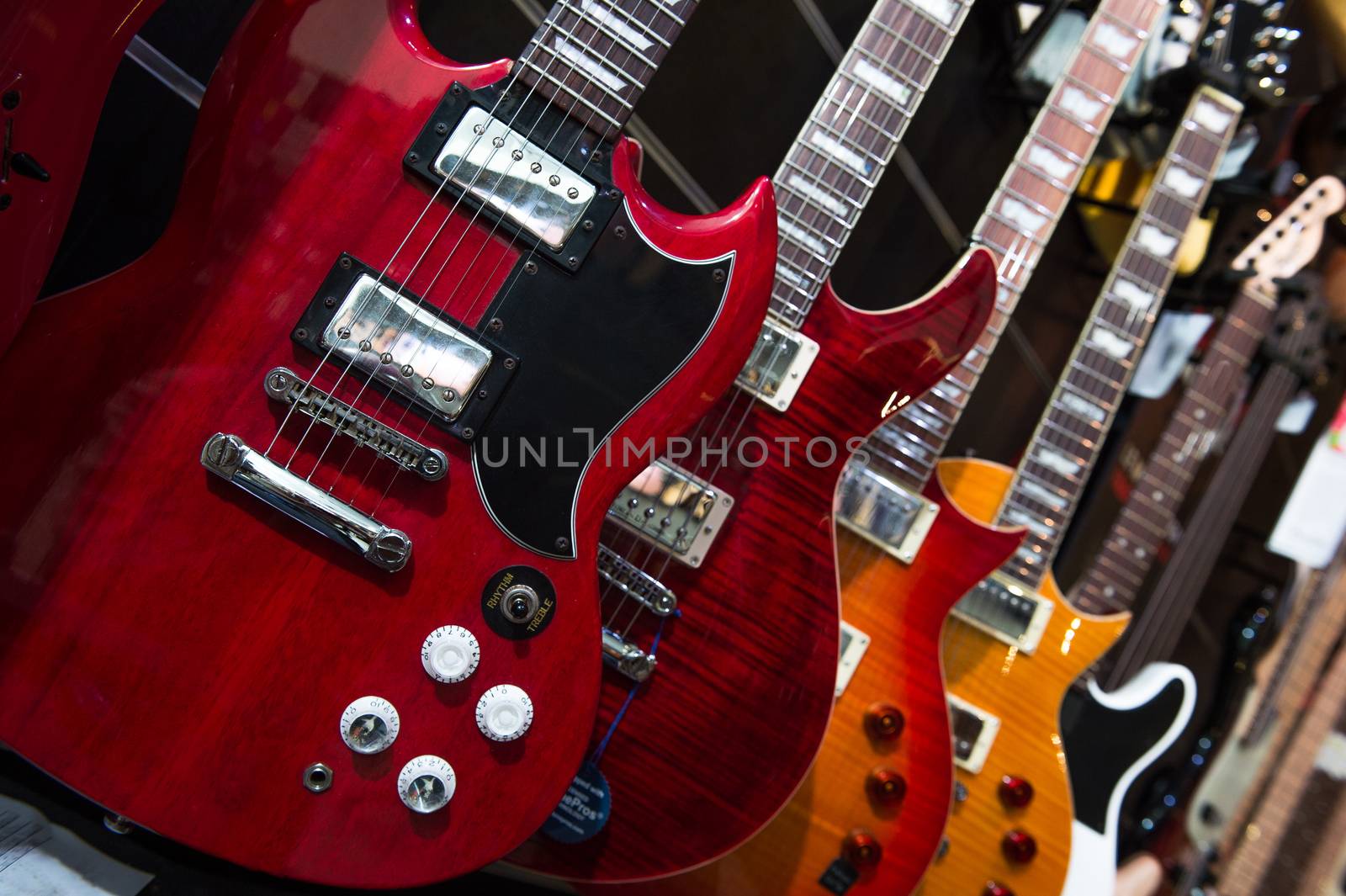 Many electric guitars hanging on wall in the shop, France