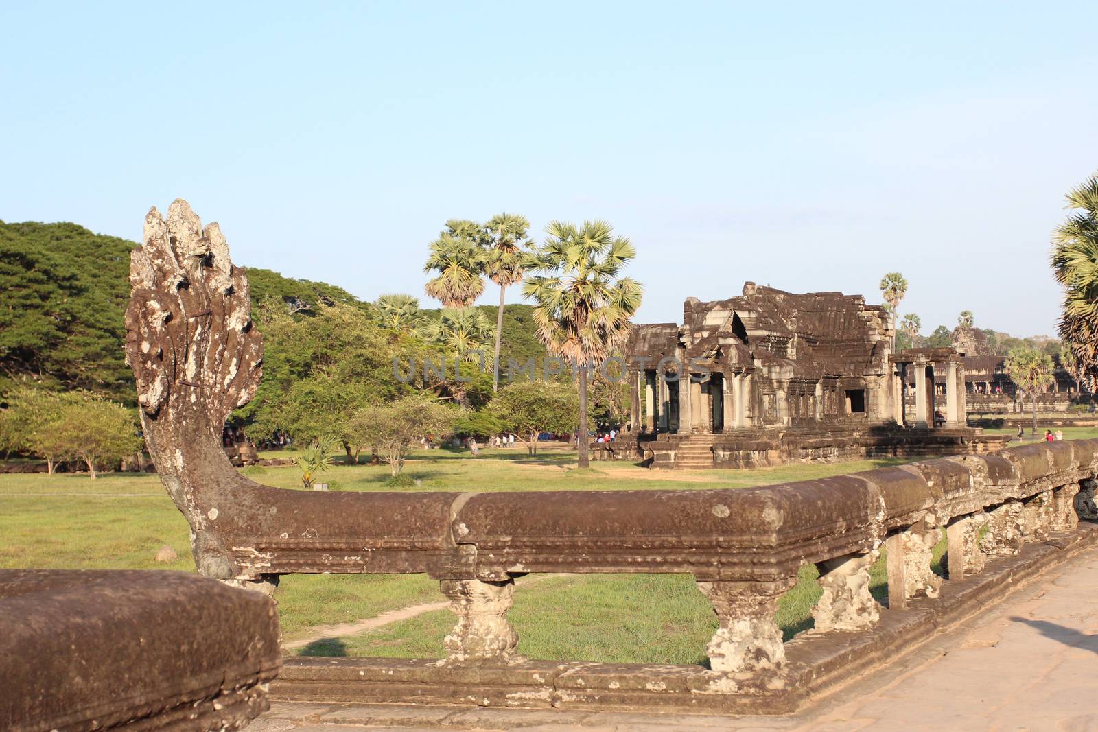 The setting sun rays on the walls of the ancient city of Angkor in Cambodia, near Siem Reap