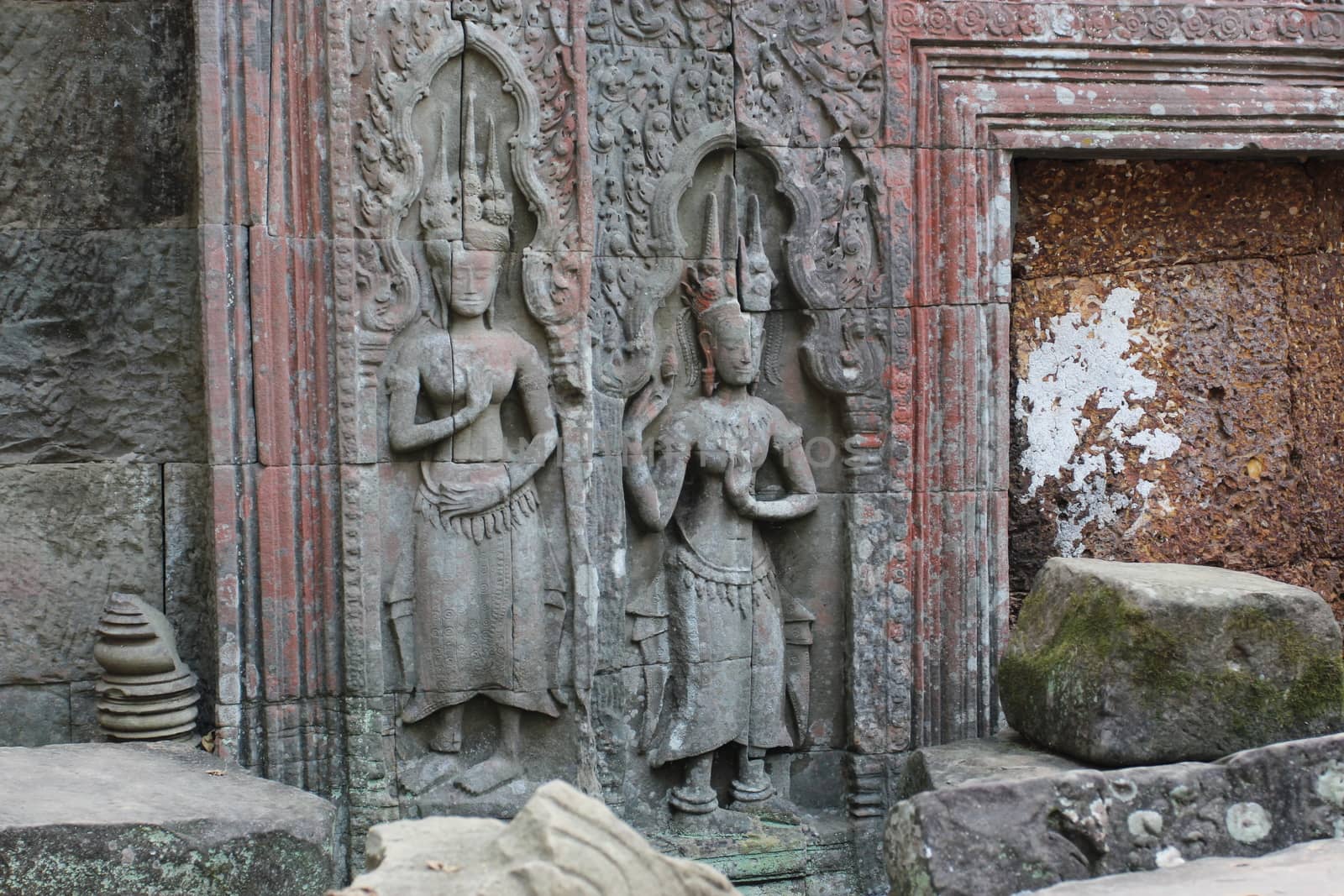 A beautiful ancient relief on the wall of a Cambodian Buddhist temple from Angkor complex, near the antique city of Siem Reap.