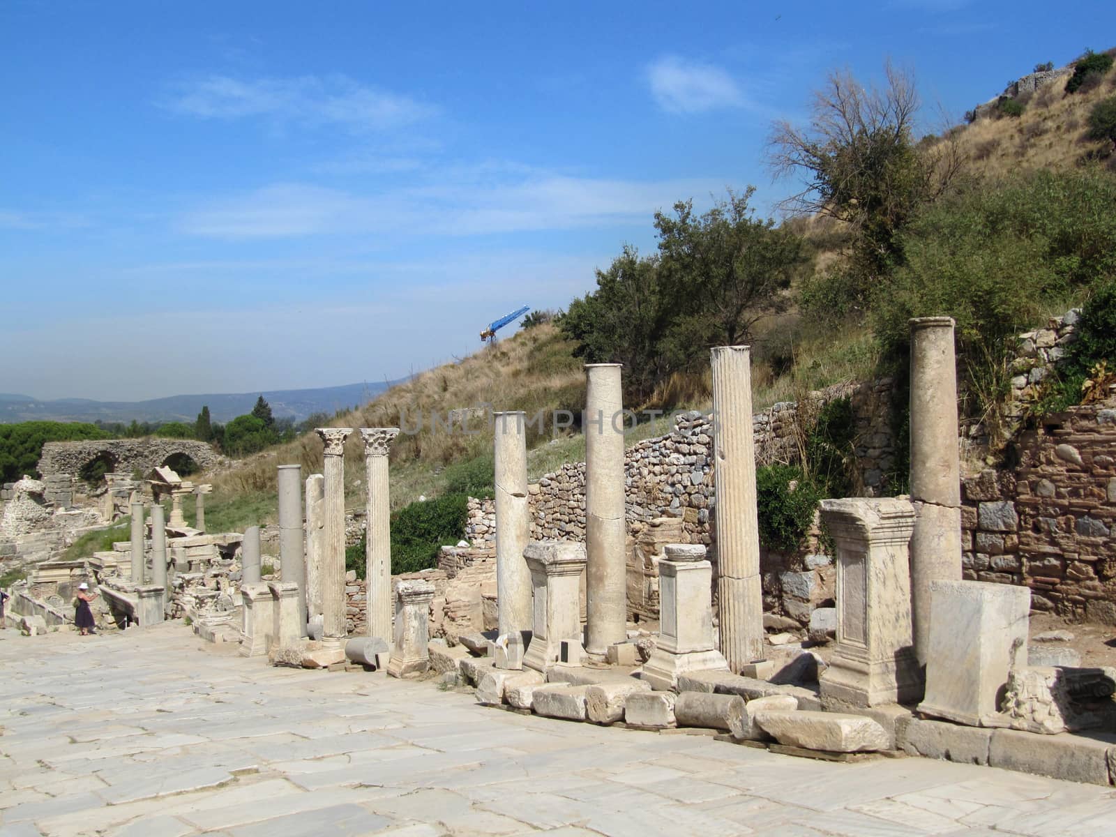 The ruins of an ancient Greek city in the background of hills and green cypresses. Turkey