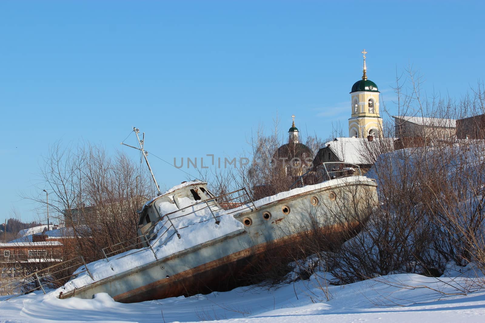 Broken boat on a winter city background