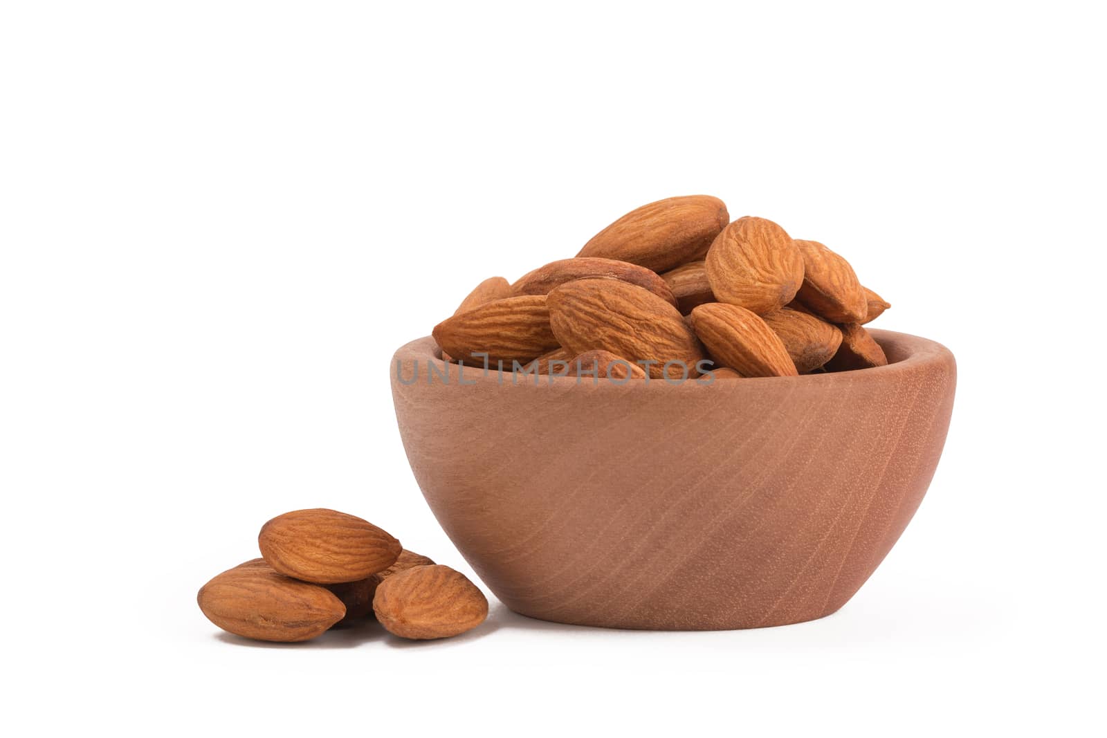 Bio organic almonds in wooden bowl isolated on white background. by ivo_13