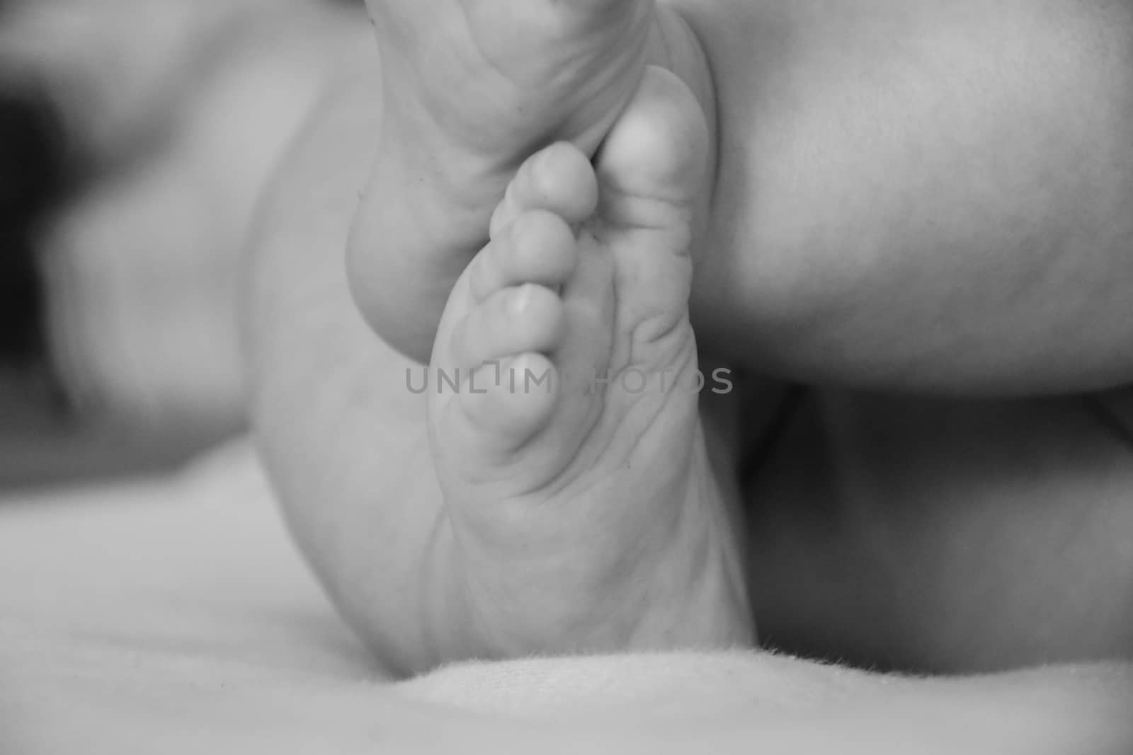 Baby, infant feet black and white photo, beautiful background for card,  banner, wallpaper design 