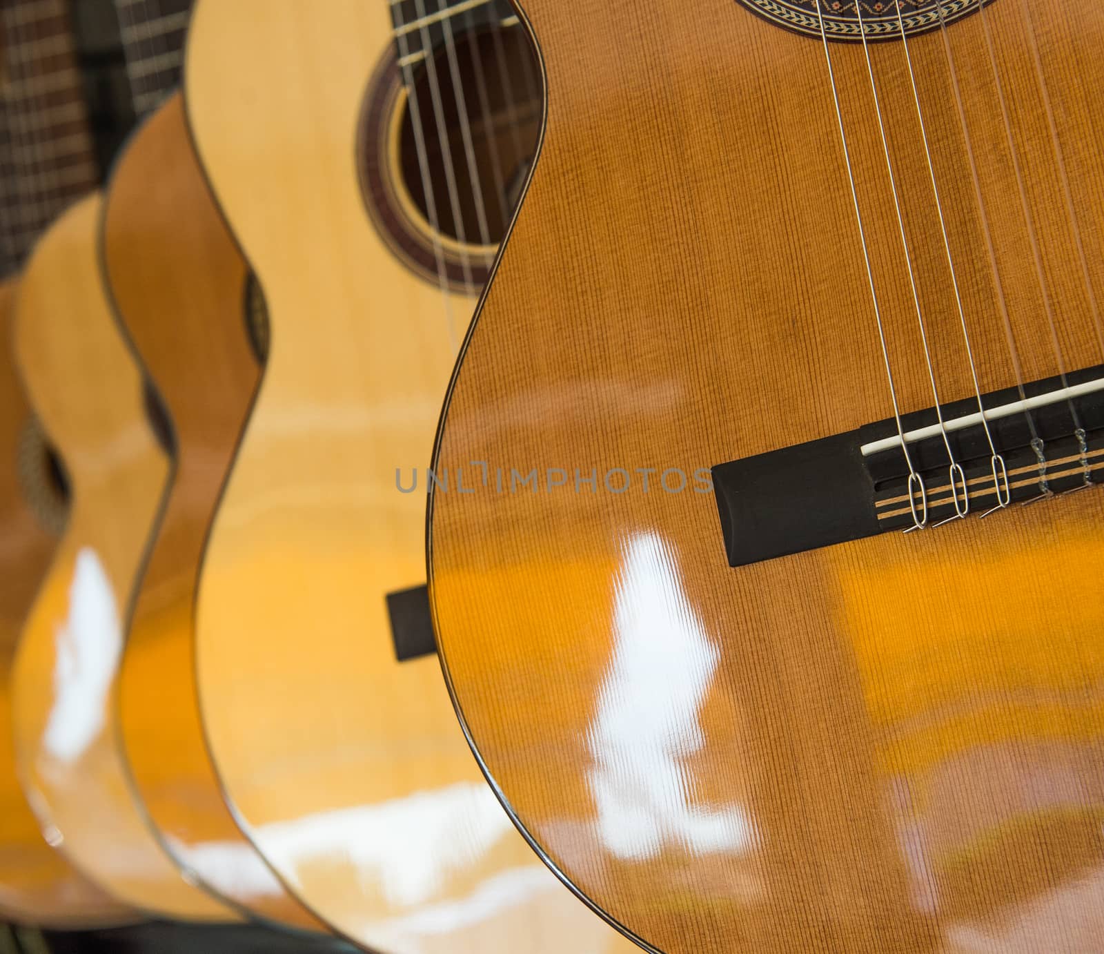 Many Classical Guitars Hanging on Wall in the Shop, France