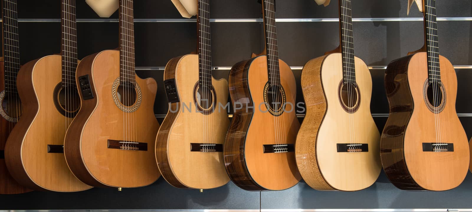 Many Classical Guitars Hanging on Wall in the Shop, France