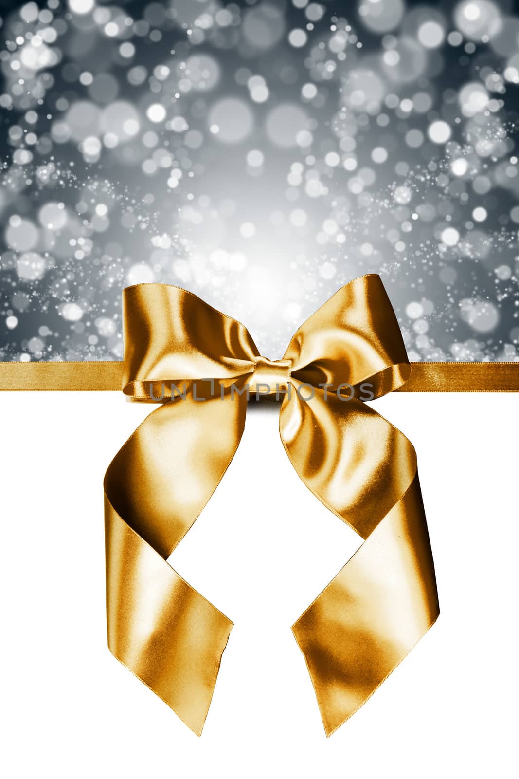 Golden gift ribbon bow and bokeh isolated on white background