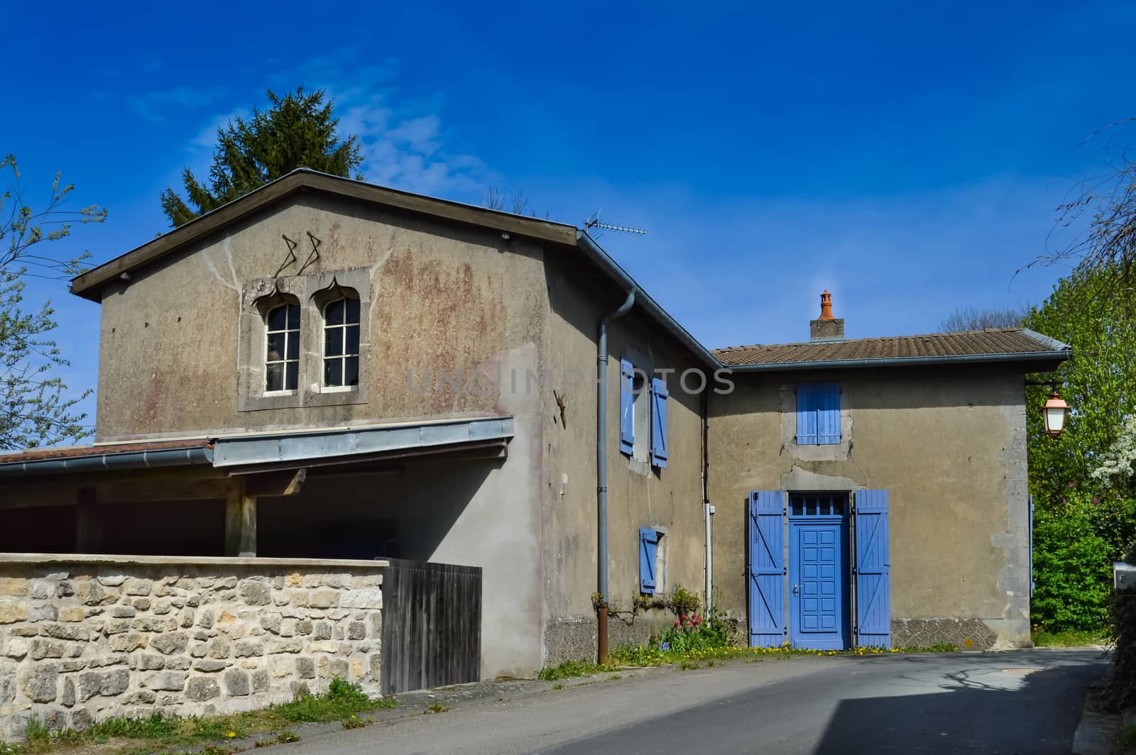 Small house with blue shutters in a small village near the lake of madine in the department of the meuse in France