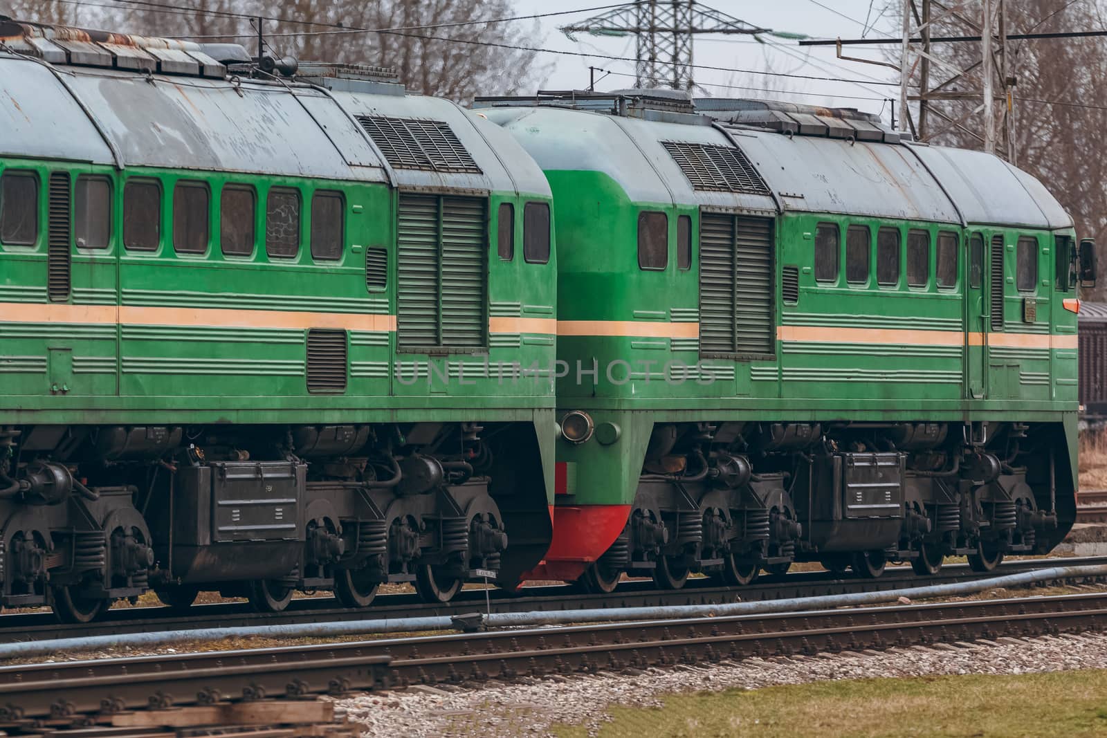 Green diesel cargo locomotive. Freight train in action