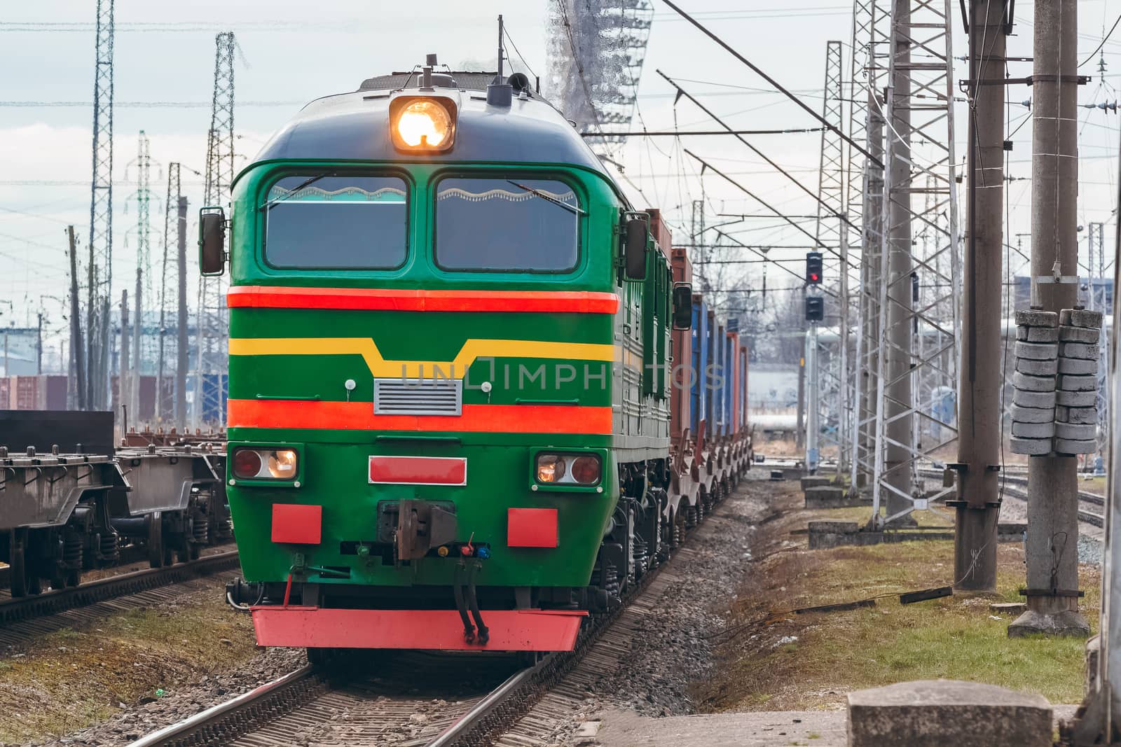 Green diesel cargo locomotive. Freight train in action