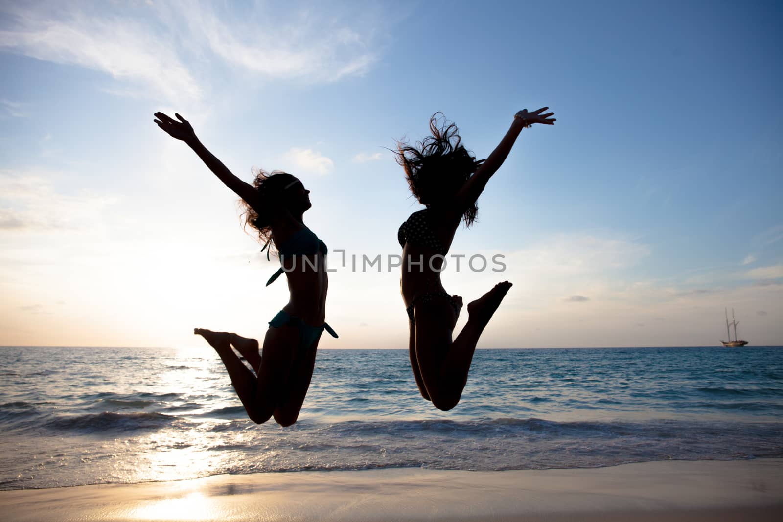 Happy young people on beach by ALotOfPeople