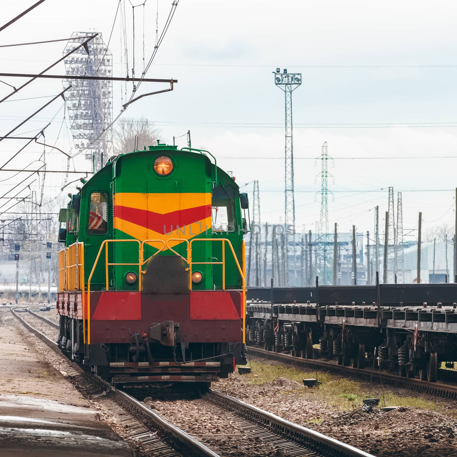 Green diesel cargo locomotive. Freight train in action