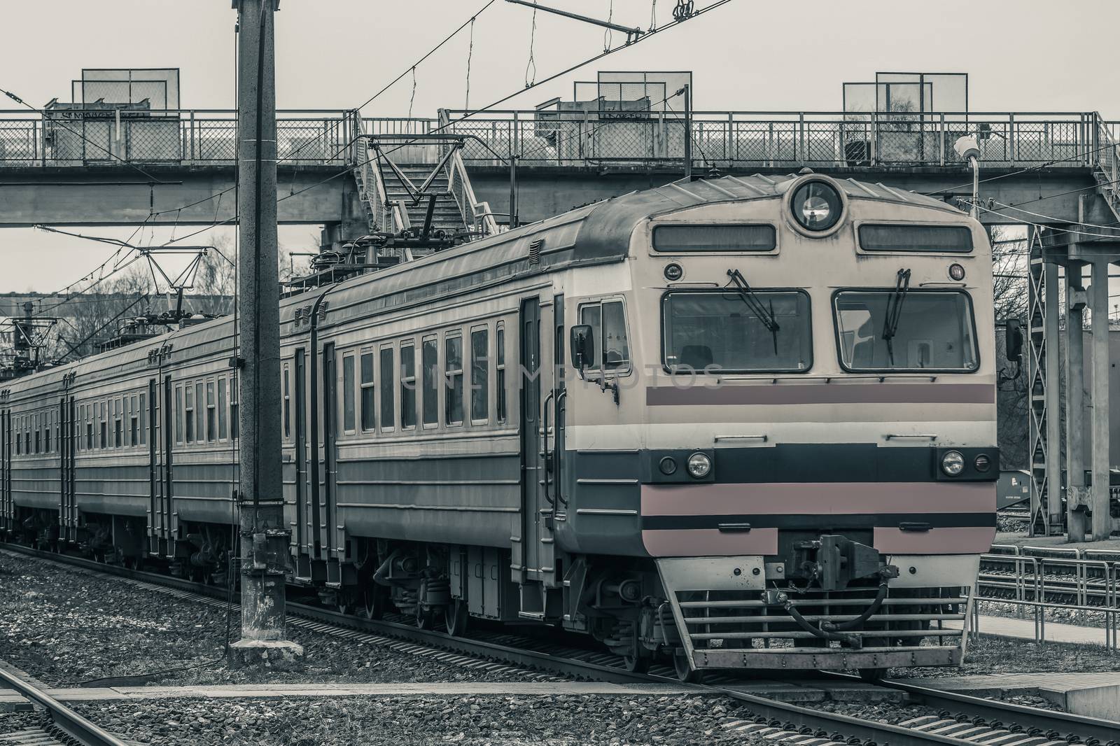 Old passenger electric train riding at the terminal