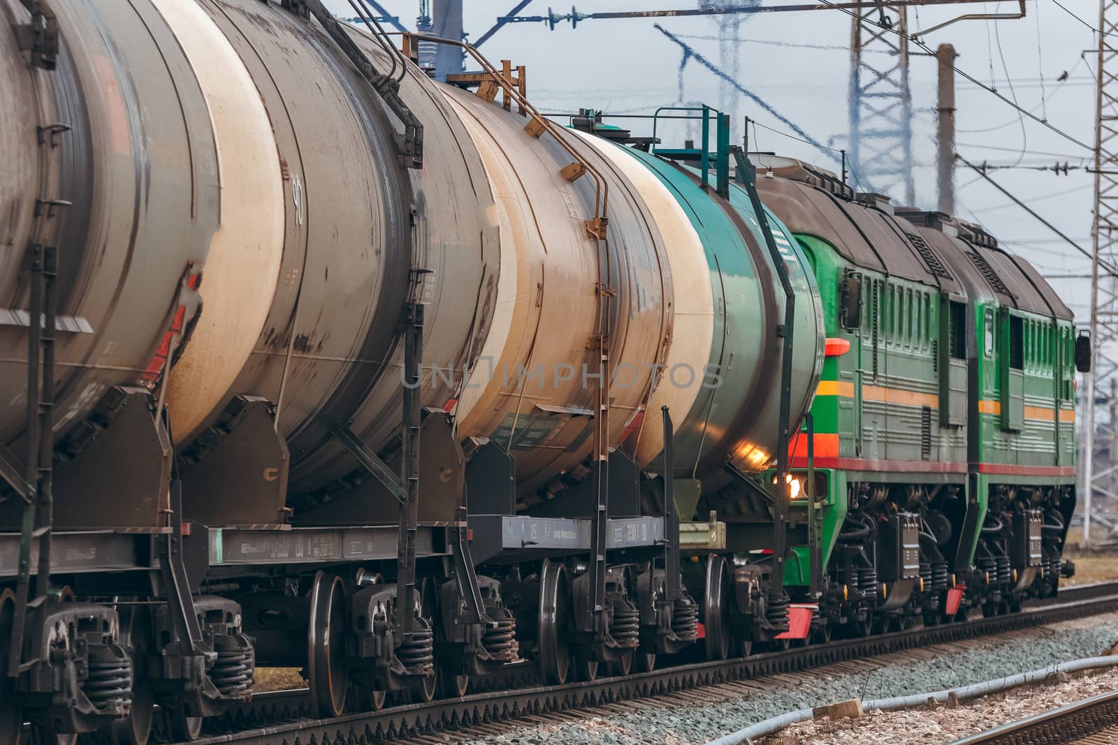 Green diesel cargo locomotive. Freight train in action