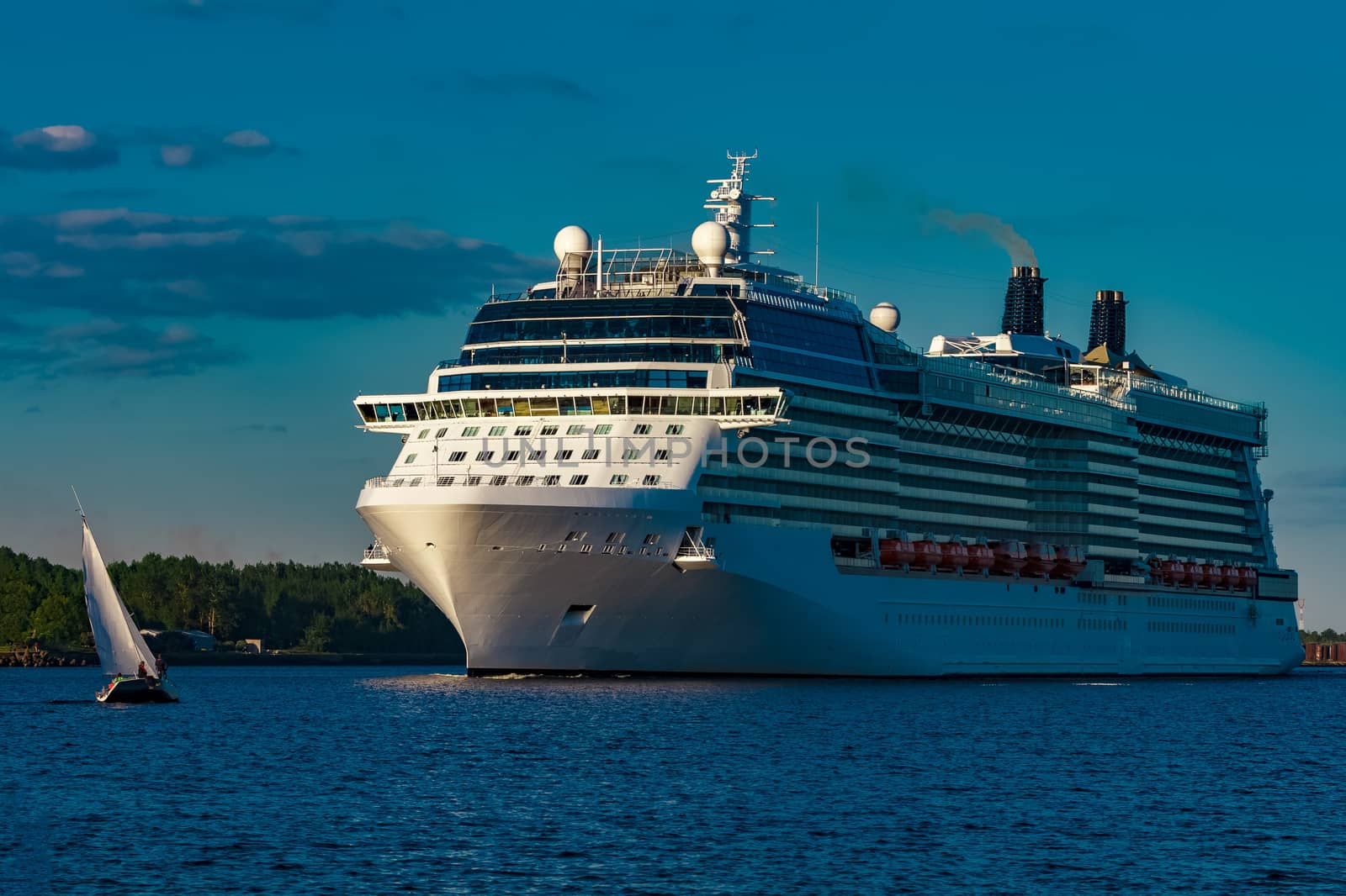 White giant brand new passenger ship moving in clear summer day