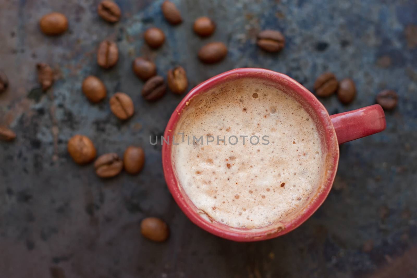 Hot coffee latte cappuccino witl milk foam in vintage ceramic cup on texture background.