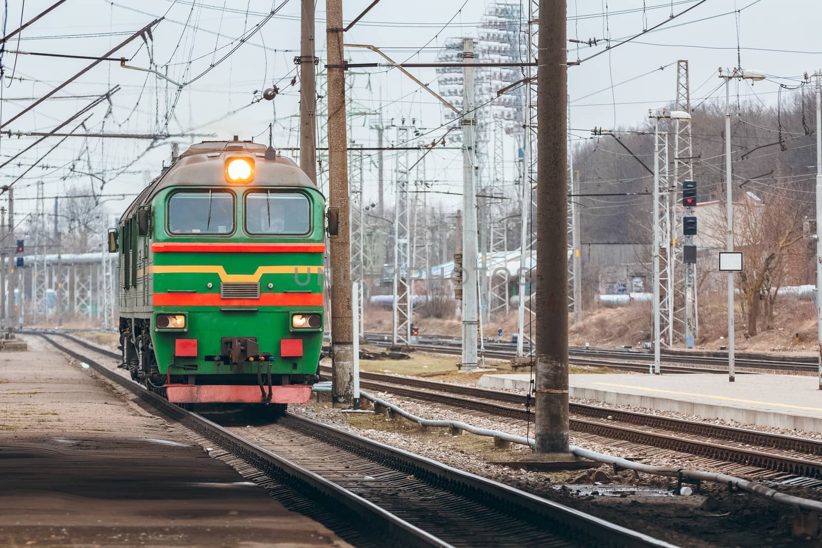 Green diesel cargo locomotive. Freight train in action