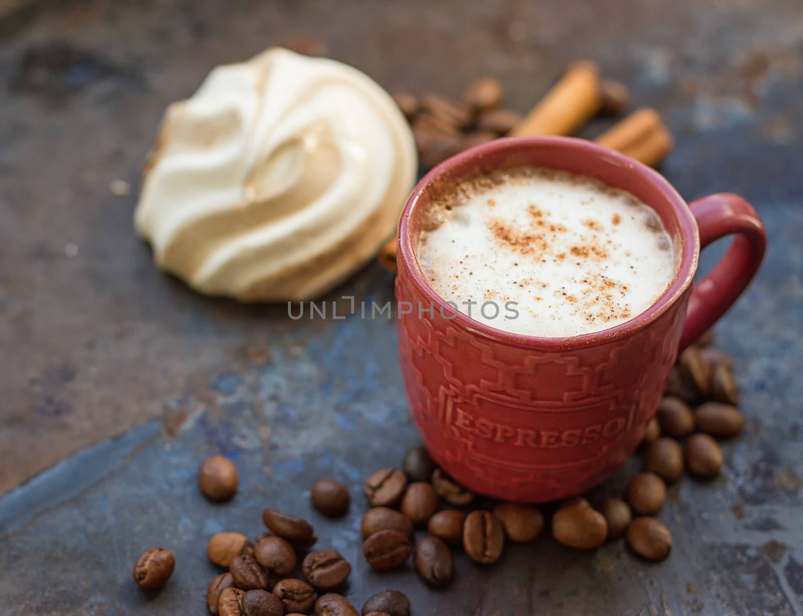 Cappuccino and chocolate marshmallows on a grunge background