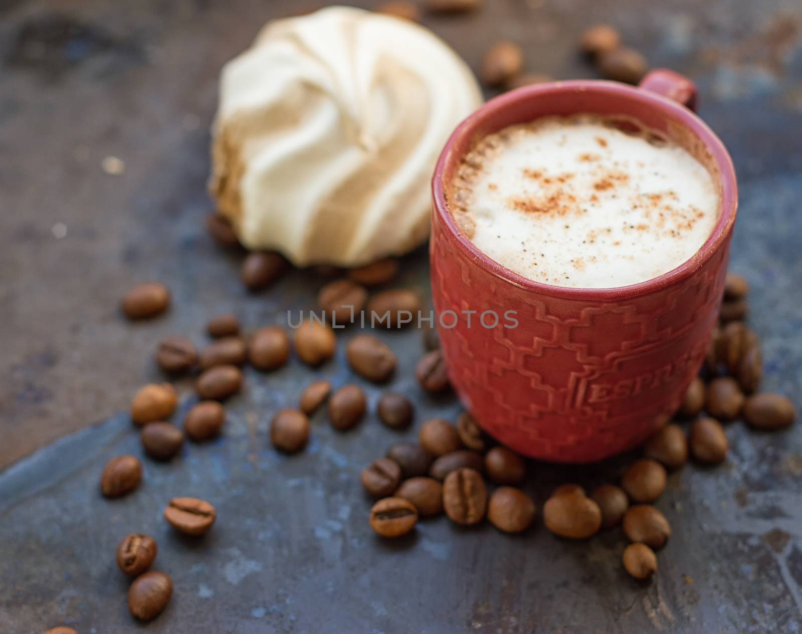 Cappuccino and chocolate marshmallows on a grunge background