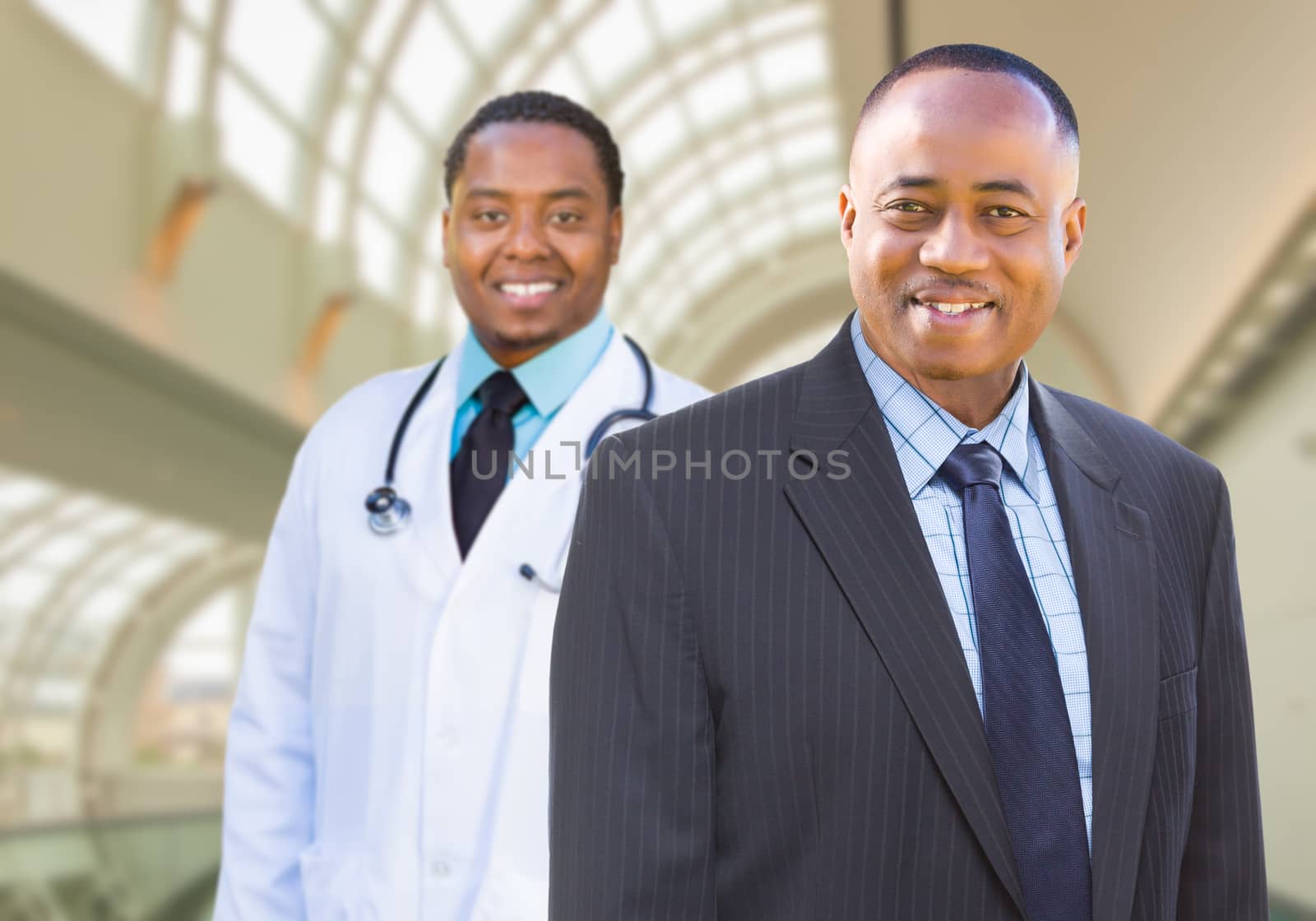 African American Businessman and Doctor Inside Medical Building.