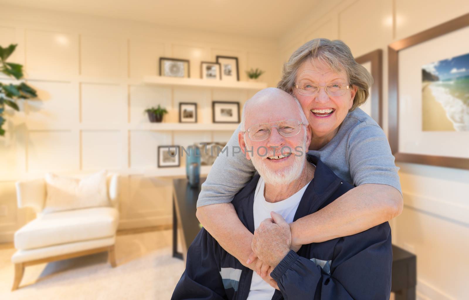 Loving Senior Couple Inside Their Home Office.